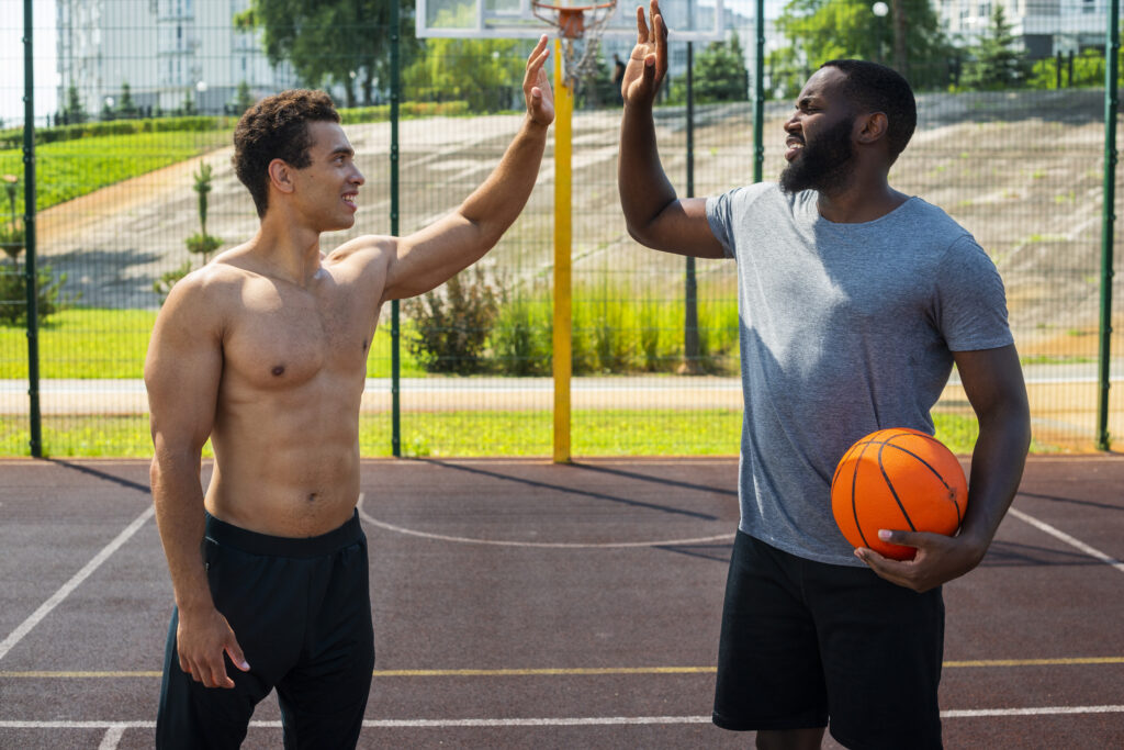 handsome men playing urban basketball medium shot
